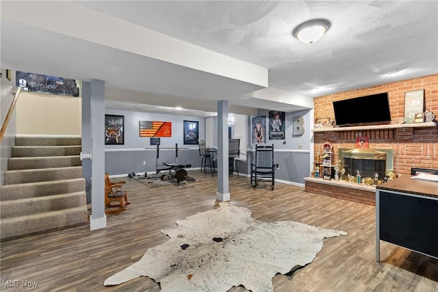 interior space featuring wood-type flooring and a brick fireplace