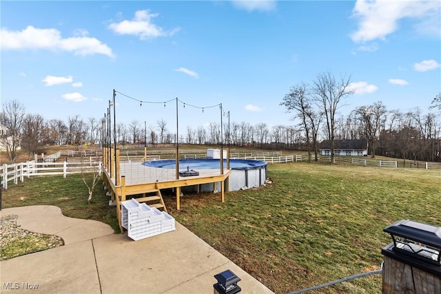 view of yard with a rural view and a covered pool