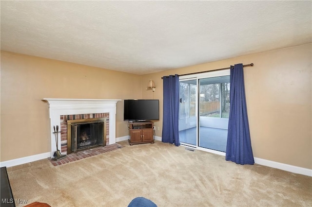 unfurnished living room with light carpet, a fireplace, and a textured ceiling