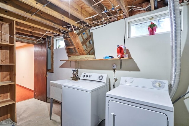 laundry room featuring washing machine and dryer, sink, and a wealth of natural light