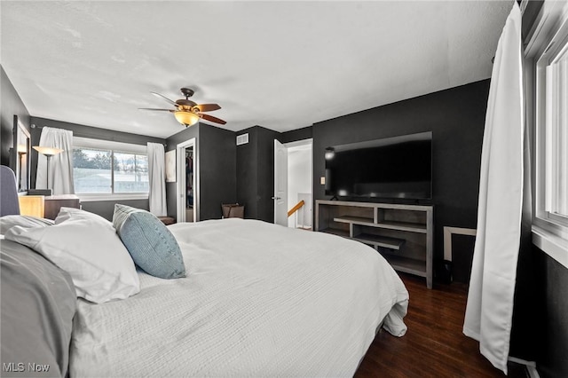 bedroom featuring ceiling fan and dark hardwood / wood-style flooring