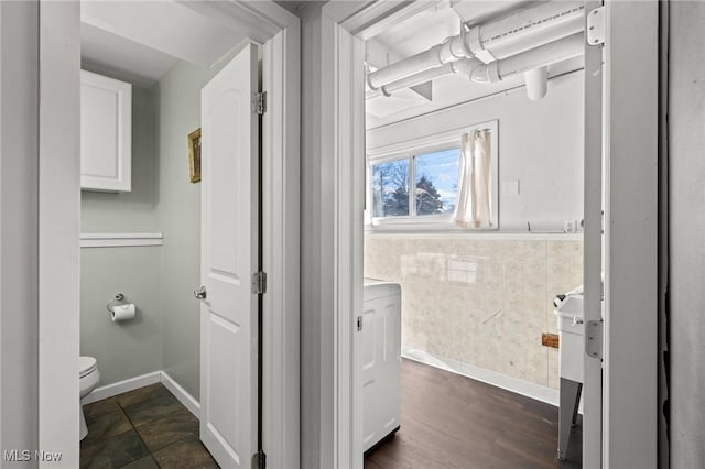 bathroom with wood-type flooring and toilet