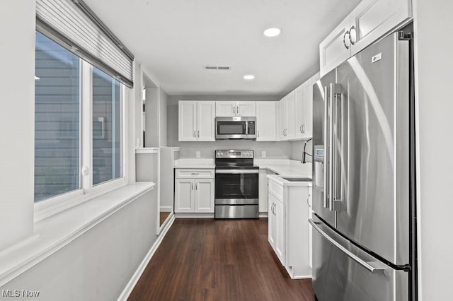 kitchen with white cabinetry, sink, dark hardwood / wood-style flooring, and stainless steel appliances