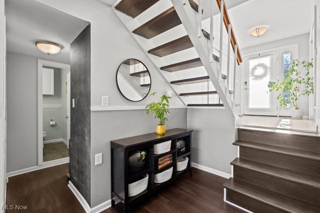 stairs featuring wood-type flooring