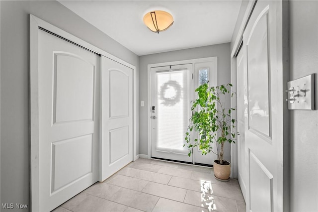 foyer entrance with light tile patterned flooring