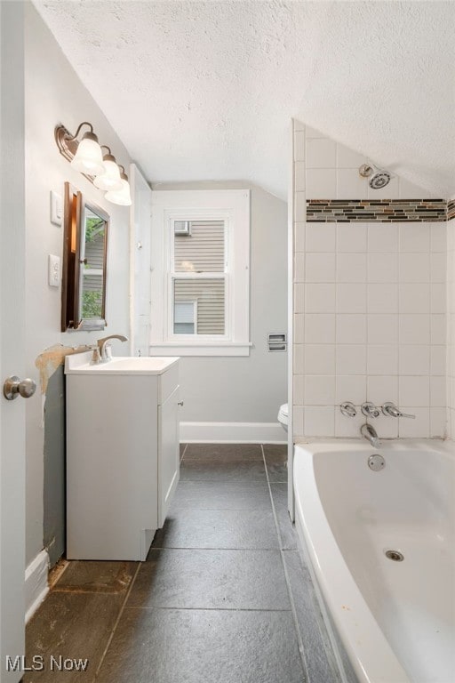 full bathroom featuring vanity, lofted ceiling, a textured ceiling, and toilet