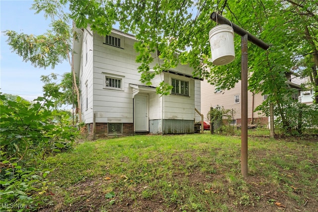 rear view of property with a yard