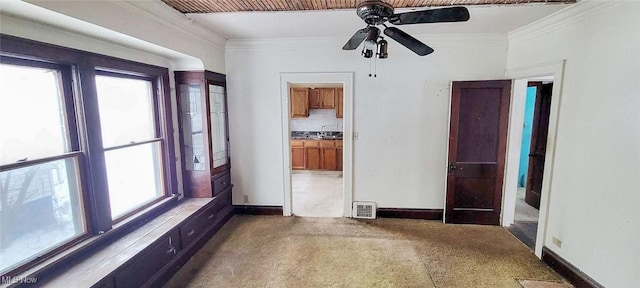 spare room featuring crown molding and ceiling fan