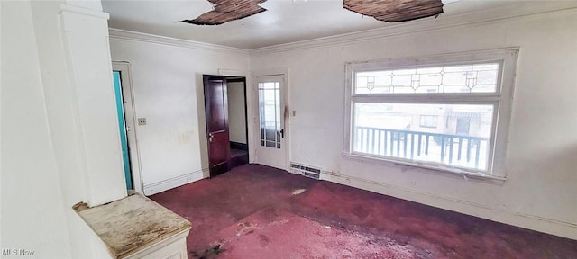 empty room featuring crown molding