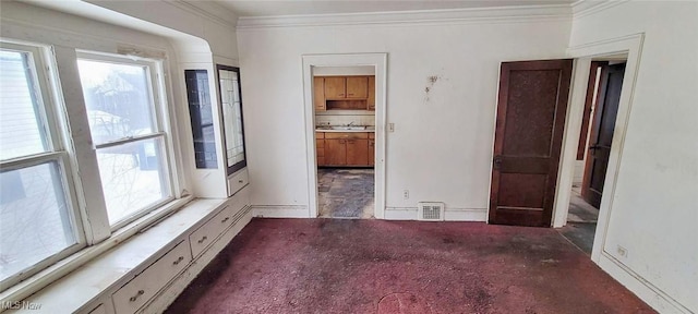 carpeted spare room featuring sink and ornamental molding