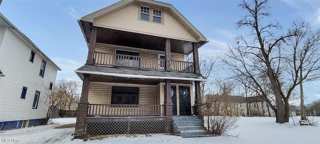 view of front of property featuring a balcony and covered porch