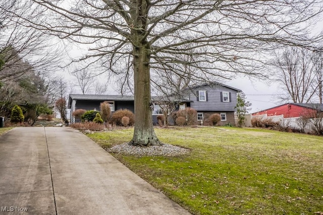 split level home featuring a front lawn