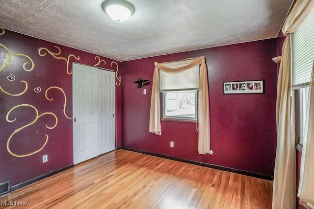 interior space with hardwood / wood-style floors and a textured ceiling