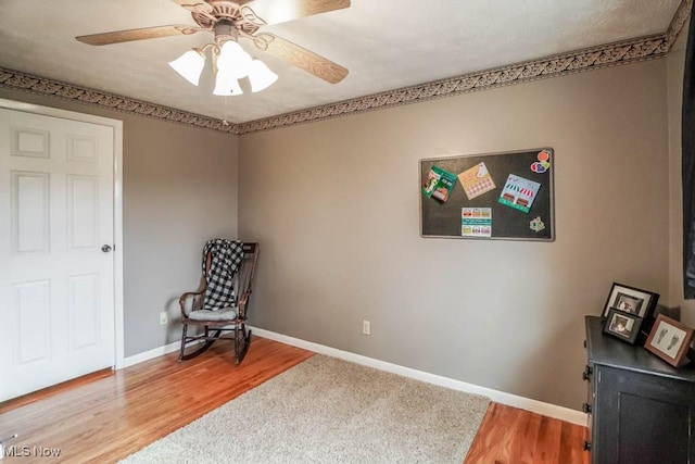 living area featuring ceiling fan and hardwood / wood-style floors