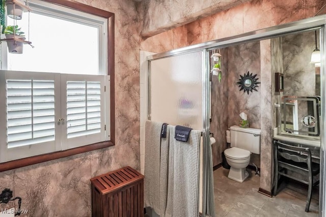 bathroom featuring plenty of natural light, radiator, a shower with shower door, and toilet