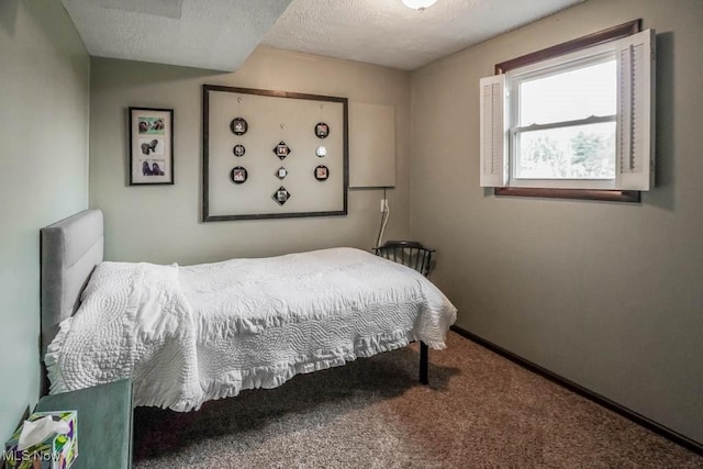 bedroom with a textured ceiling and carpet