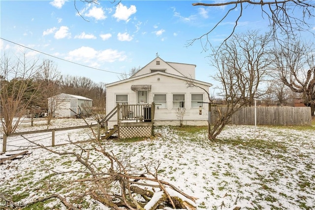 view of snow covered back of property