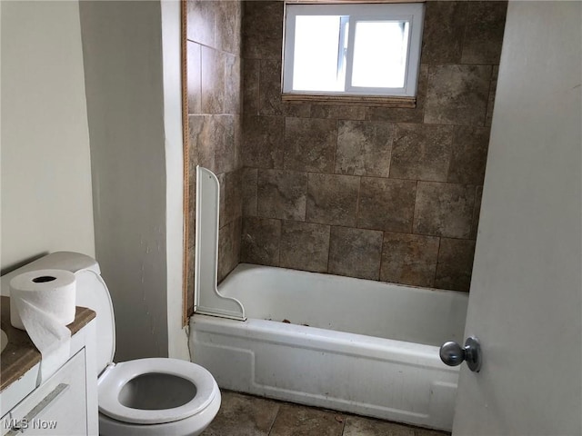 full bathroom featuring vanity, tiled shower / bath, tile patterned floors, and toilet