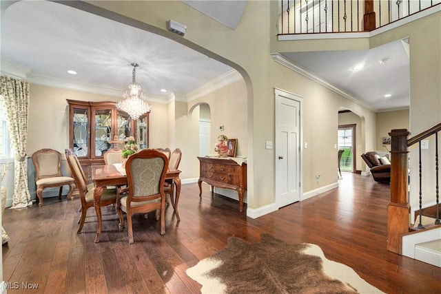 dining space with an inviting chandelier, dark wood-type flooring, and ornamental molding