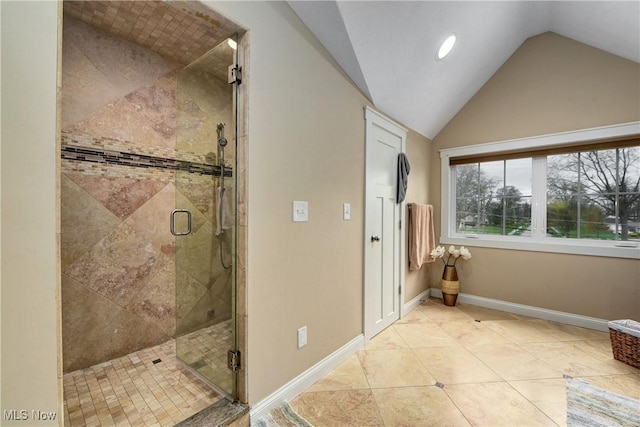 bathroom featuring vaulted ceiling, tile patterned floors, and a shower with door