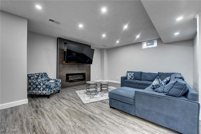 living room featuring hardwood / wood-style flooring and a fireplace