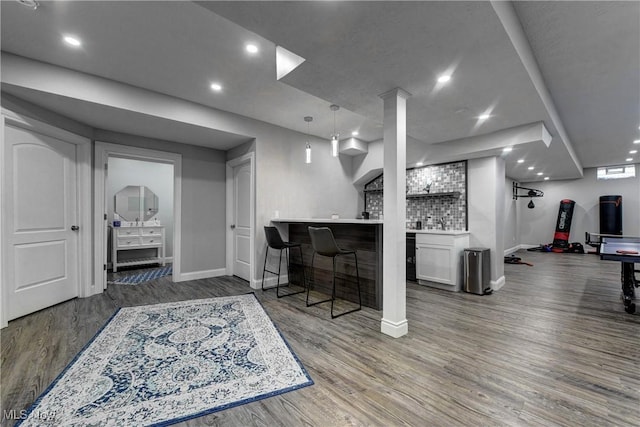 interior space featuring dark hardwood / wood-style flooring and bar area