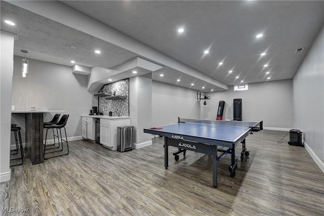 playroom featuring hardwood / wood-style flooring and indoor wet bar