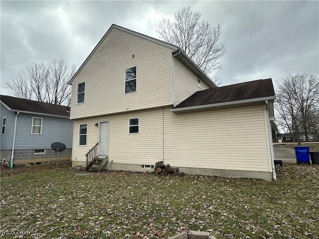 rear view of house with a lawn