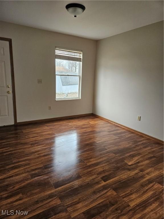 empty room featuring dark hardwood / wood-style flooring