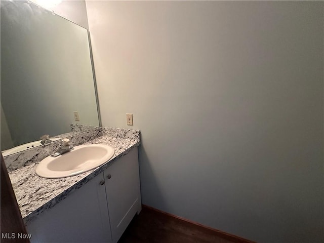 bathroom with vanity and baseboards