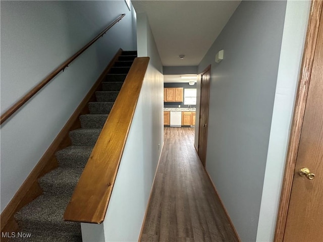 stairs with wood finished floors and baseboards