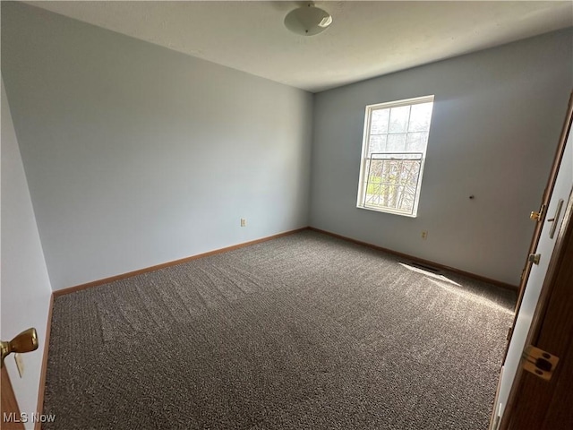 unfurnished room featuring baseboards and carpet flooring