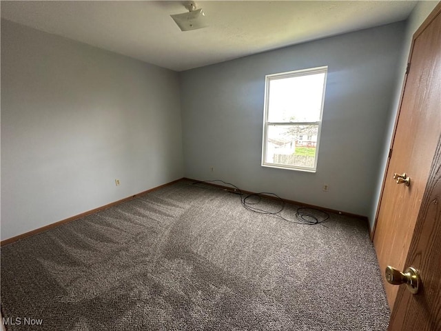 unfurnished bedroom with baseboards and carpet flooring