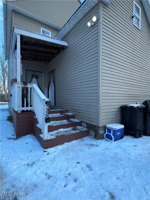 view of snow covered property entrance