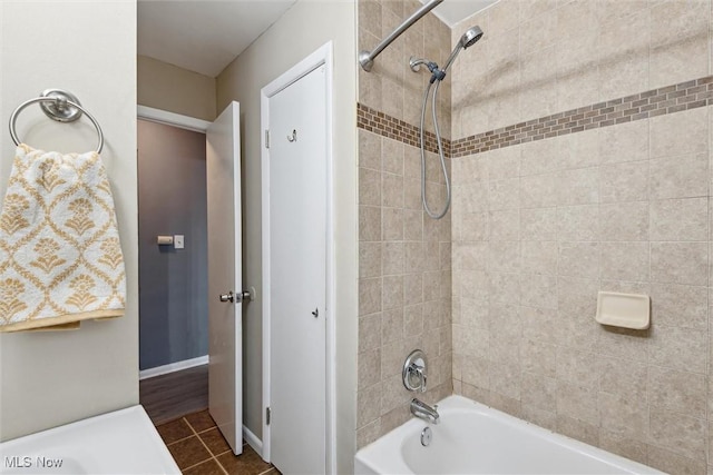 bathroom featuring tiled shower / bath and tile patterned floors