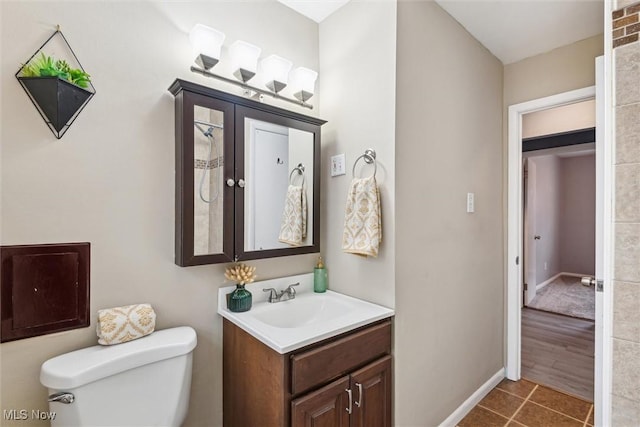 bathroom featuring vanity, toilet, and tile patterned flooring