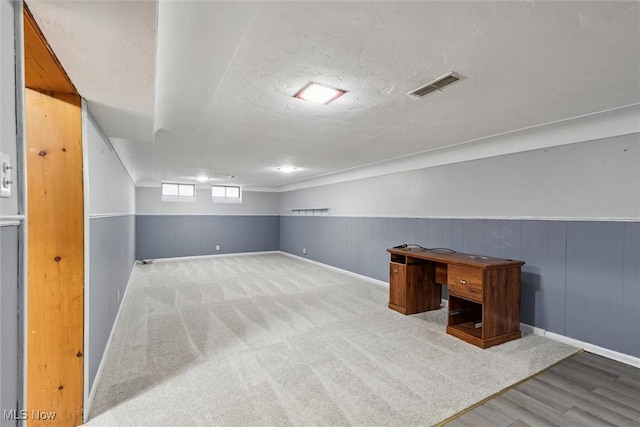 additional living space with carpet and a textured ceiling