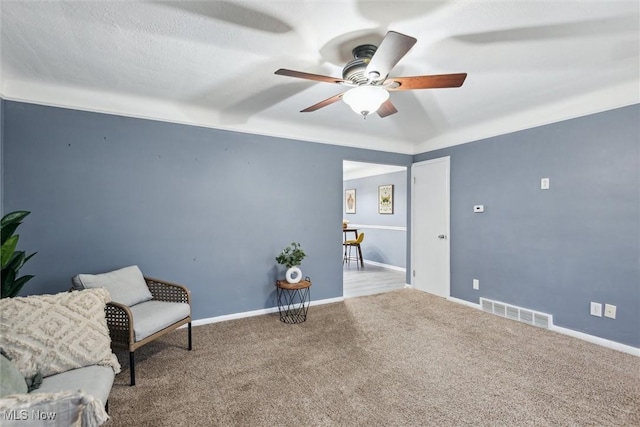 unfurnished room with ceiling fan and carpet