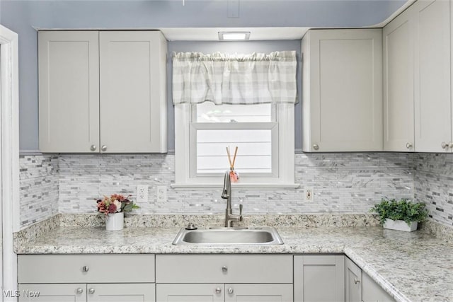 kitchen with tasteful backsplash and sink