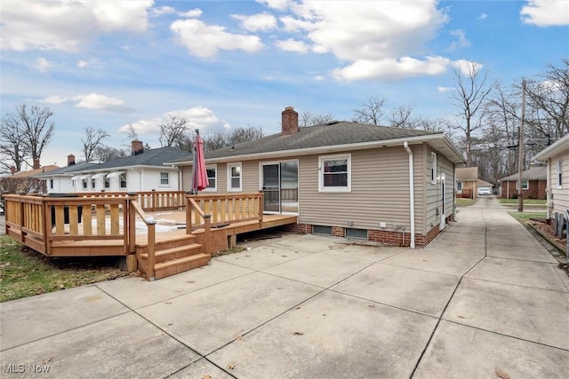 back of house featuring a wooden deck