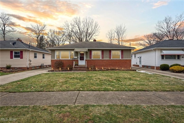 ranch-style home featuring a lawn