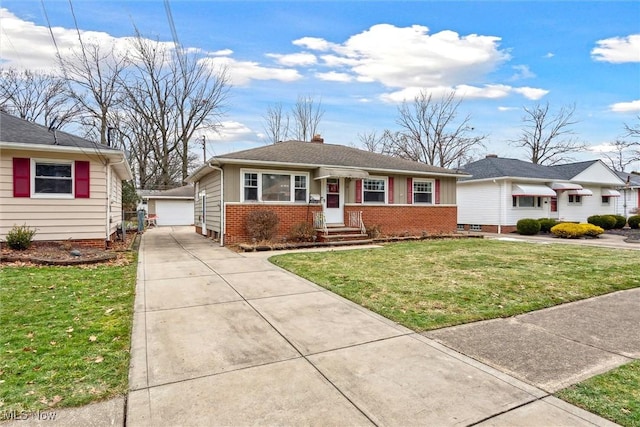 view of front of house featuring an outbuilding, a garage, and a front yard