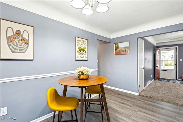 dining room featuring hardwood / wood-style flooring and an inviting chandelier