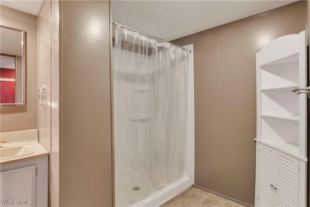 bathroom featuring vanity and curtained shower