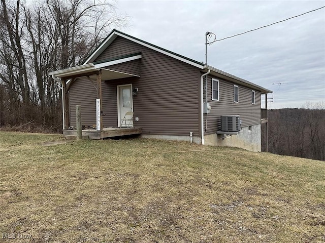 exterior space featuring a yard and central AC unit