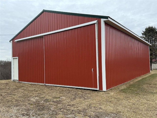 view of outbuilding with a yard