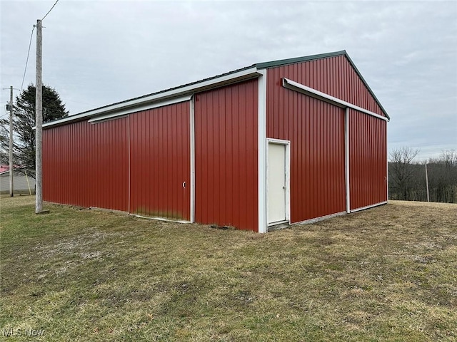 view of outbuilding featuring a yard