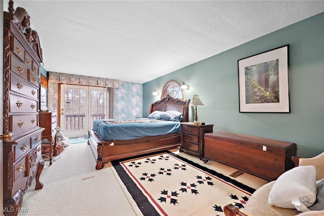 bedroom featuring access to exterior, light carpet, and a textured ceiling