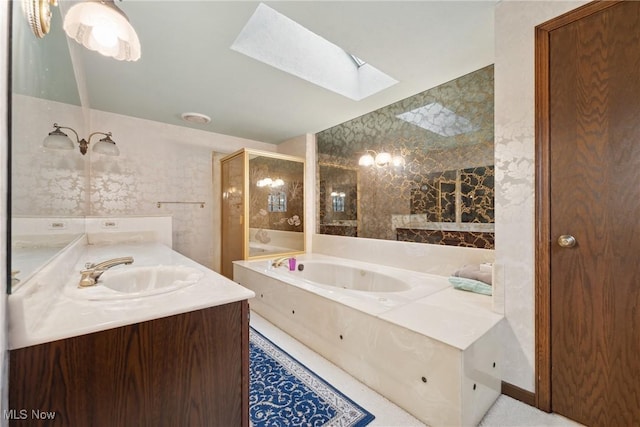 bathroom featuring vanity, a skylight, and independent shower and bath