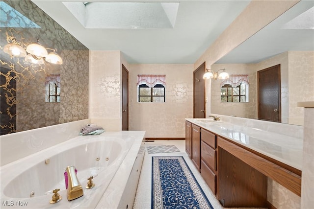 bathroom with vanity, a bathtub, and plenty of natural light